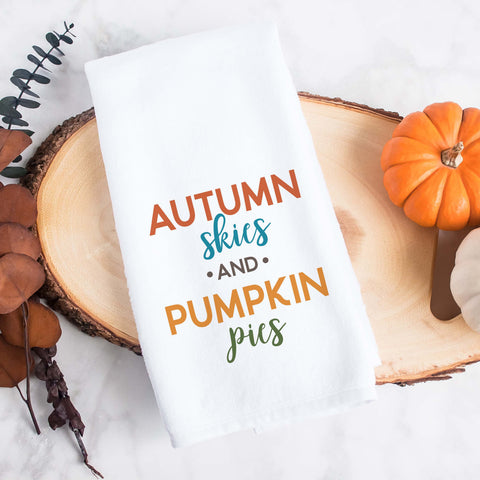 A fall tea towel printed with autumn skies and pumpkin pies.  This can be used as a hand towel, kitchen towel, decorative towel, bathrooom towel, and more.