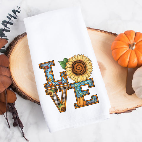 the word love decorated with fall leaves, pumpkins, and sunflowers on a kitchen tea towel, decorative hand towel, modern farmhouse style home decor, kitchen decor, bathroom decor