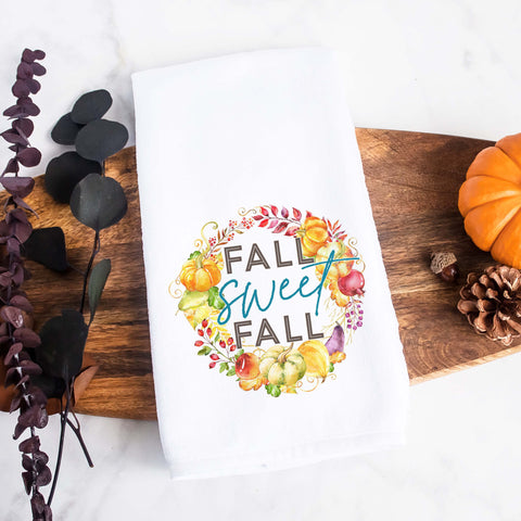 A fall tea towel printed with fall sweet fall in a wreath made of pumpkins, flowers and gourds.  This can be used as a hand towel, kitchen towel, decorative towel, bathrooom towel, and more.