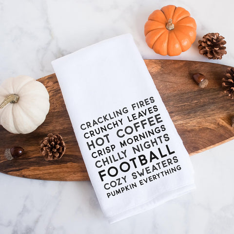 A fall tea towel printed with fall favorites: crackling fires, crunchy leaves, hot coffee, crisp mornings, chilly nights, football, cozy sweaters, pumpkin everything.  This can be used as a hand towel, kitchen towel, decorative towel, bathrooom towel, and more.