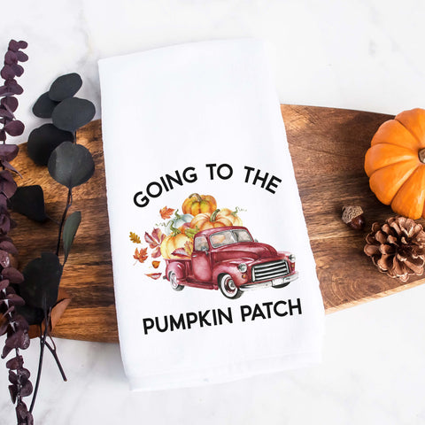 white kitchen tea towel printed with going to the pumpkin patch and a fall red truck with pumpkins.  Decorative Towel printed with the text going to the pumpkin patch