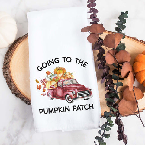 white kitchen tea towel printed with going to the pumpkin patch and a fall red truck with pumpkins.  Decorative Towel printed with the text going to the pumpkin patch