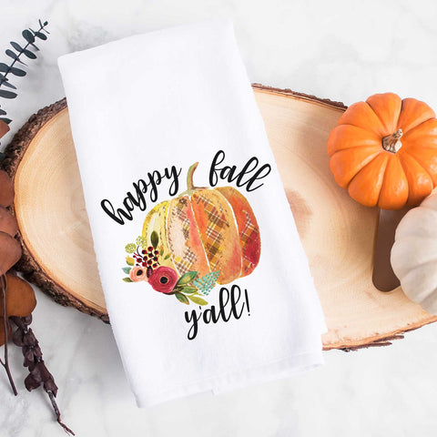 White kitchen tea towel printed with happy fall y'all and a pumpkin with flowers.  Decorative Towel with happy fall y'all.