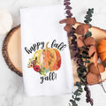 White kitchen tea towel printed with happy fall y'all and a pumpkin with flowers.  Decorative Towel with happy fall y'all.