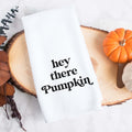 White kitchen tea towel printed with hey there pumpkin.  Decorative Towel printed with the text hey there pumpkin.