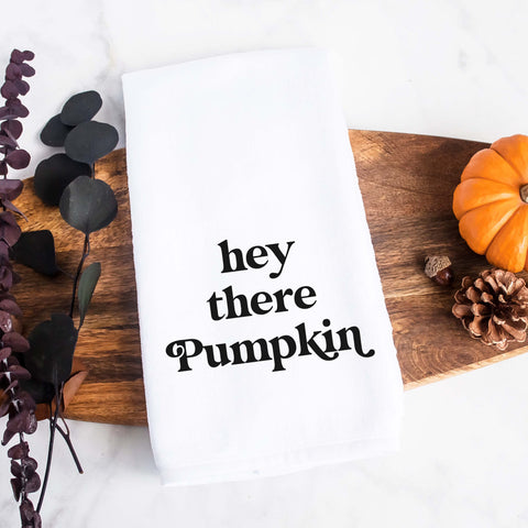 White kitchen tea towel printed with hey there pumpkin.  Decorative Towel printed with the text hey there pumpkin.
