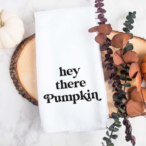 White kitchen tea towel printed with hey there pumpkin.  Decorative Towel printed with the text hey there pumpkin.
