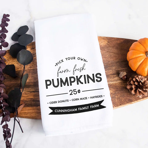 Personalized white kitchen tea towel printed with farm fresh pumpkins and a family last name.  Personalized Decorative Towel printed with the text farm fresh pumpkins.