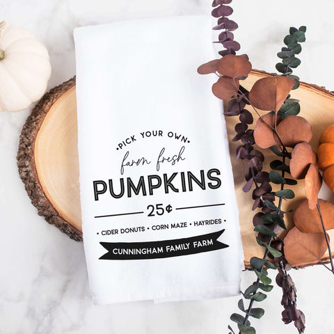 Personalized white kitchen tea towel printed with farm fresh pumpkins and a family last name.  Personalized Decorative Towel printed with the text farm fresh pumpkins.