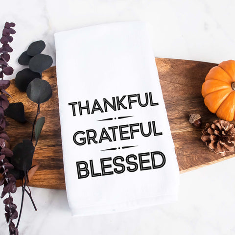 white kitchen tea towel printed with thankful grateful blessed.  Decorative Towel printed with the text thankful grateful blessed.